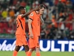Netherlands' defender #22 Denzel Dumfries and forward #09 Wout Weghorst react after losing the penalty shootout.(AFP)