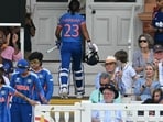 India's captain Harmanpreet Kaur walks back to the pavilion having lost her wicket against Australia. (AFP)