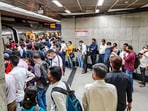 New Delhi: Commuters wait in a queue to board a metro at a platform at a metro station after services on the Blue Line were delayed, in New Delhi, 
