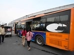 Passengers board a city bus at Polytechnic crossing in Lucknow. (Deepak Gupta/HT photo)