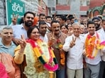 Suman Thakur and Jitendra Kumar celebrating their victory in Mandi on Monday. (Birbal Sharma/HT)