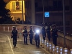 Monaco police officers patrol near the site of an explosion in a residential building in Monaco, near the French border, on June 29