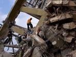 A rescuer works at the site of a collapsed building in the aftermath of earthquakes in La Guaira, Venezuela on Monday.