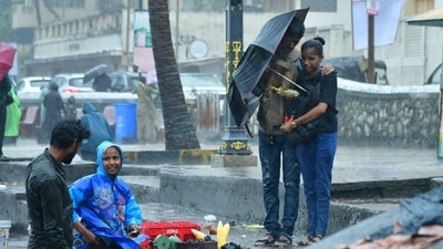 People walk through the Rain at Bandra Bandstand, in Mumbai. (HT Photo/Bhushan Koyande)