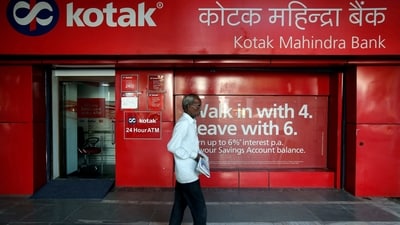 FILE PHOTO: A man walks past the Kotak Mahindra Bank branch in New Delhi. (REUTERS/Adnan Abidi/File Photo)