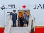 Japan Prime Minister Sanae Takaichi waves as she arrives to India for her first official visit, in New Delhi on Wednesday.