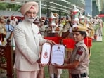 Delhi LG Taranjit Singh Sandhu felicitates a police official during the Delhi Police Commissionerate Day in New Delhi. (PTI)