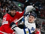 Canada's defender #25 Darnell Nurse (L) vies Finland's forward #94 Konsta Helenius during the IIHF Ice Hockey Men's World Championship semi-final match between Canada and Finland at the Swiss Life Arena in Zurich, on May 30, 2026.