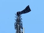 Two people display a banner atop the Empire State Building in the Manhattan borough of New York, U.S., July 1, 2026.  REUTERS/Adam Gray