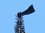 Two people display a banner atop the Empire State Building in the Manhattan borough of New York, U.S., July 1,