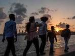 People walk along the seafront during sunset in Mumbai on May 25, 2026. (AFP FILE)