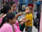 People are seen eating ice cream to beat the heat on a hot evening at Connaught Place in New Delhi.