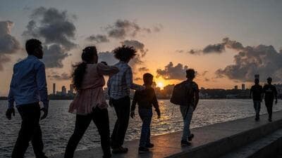 People walk along the seafront during sunset in Mumbai on May 25, 2026. (AFP FILE) People walk along the seafront during sunset in Mumbai on May 25, 2026. (AFP FILE)