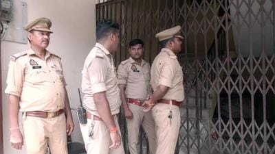 Police personnel stand outside the yoga centre premises linked to Avinash Shukla, an arrested accused in the Ram temple donations alleged theft case, during a raid, in Ayodhya on Wednesday. (ANI VIDEO GRAB) Police personnel stand outside the yoga centre premises linked to Avinash Shukla, an arrested accused in the Ram temple donations alleged theft case, during a raid, in Ayodhya on Wednesday. (ANI VIDEO GRAB)