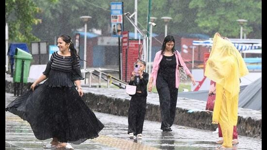 City residents enjoy the first rainfall of the monsoon season in Chandigarh on Wednesday. (Keshav Singh/ HT)