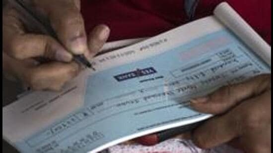 Mumbai, India - March 6, 2020: A woman fills up cheque to withdraw her money from Yes Bank branch at Fort in Mumbai, India, on Friday, March 6, 2020. (Photo by Pratik Chorge/Hindustan Times) (Pratik Chorge/HT Photo)