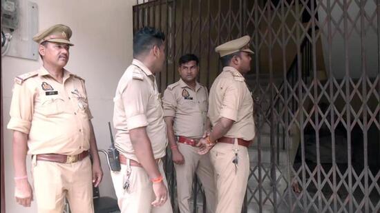 Police personnel stand outside the yoga centre premises linked to Avinash Shukla, an arrested accused in the Ram temple donations alleged theft case, during a raid, in Ayodhya on Wednesday. (ANI VIDEO GRAB)