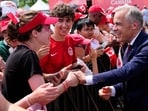 Canada Prime Minister Mark Carney greets attendees as he arrives for the Canada Day ceremony at LeBreton Flats in Ottawa, on Wednesday. (AP)