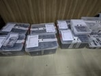 Mobile phones, hard drives and other items seized after the arrest of 119 people, who were detained after the unearthing of a fake international call centre allegedly involved in cyber fraud, kept during a press conference, in Lucknow (PTI Photo)