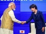 Prime Minister Narendra Modi greets Japanese Prime Minister Sanae Takaichi during the India-Japan Joint Economic Forum, in New Delhi.