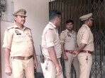 Police personnel stand outside the yoga centre premises linked to Avinash Shukla, an arrested accused in the Ram temple donations alleged theft case, during a raid, in Ayodhya on Wednesday. (ANI VIDEO GRAB)