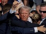 President Donald Trump is assisted by the Secret Service after gunfire rang out during a campaign rally at the Butler Farm Show in Butler, Pennsylvania, U.S., July 13, 2024. REUTERS/Brendan McDermid/File Photo
