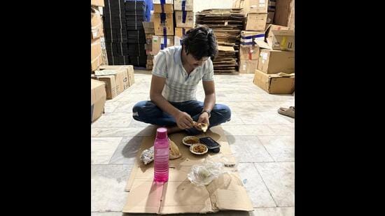 Young Aamir is eating rajma-roti while watching YouTube videos on his phone. (HT Photo)