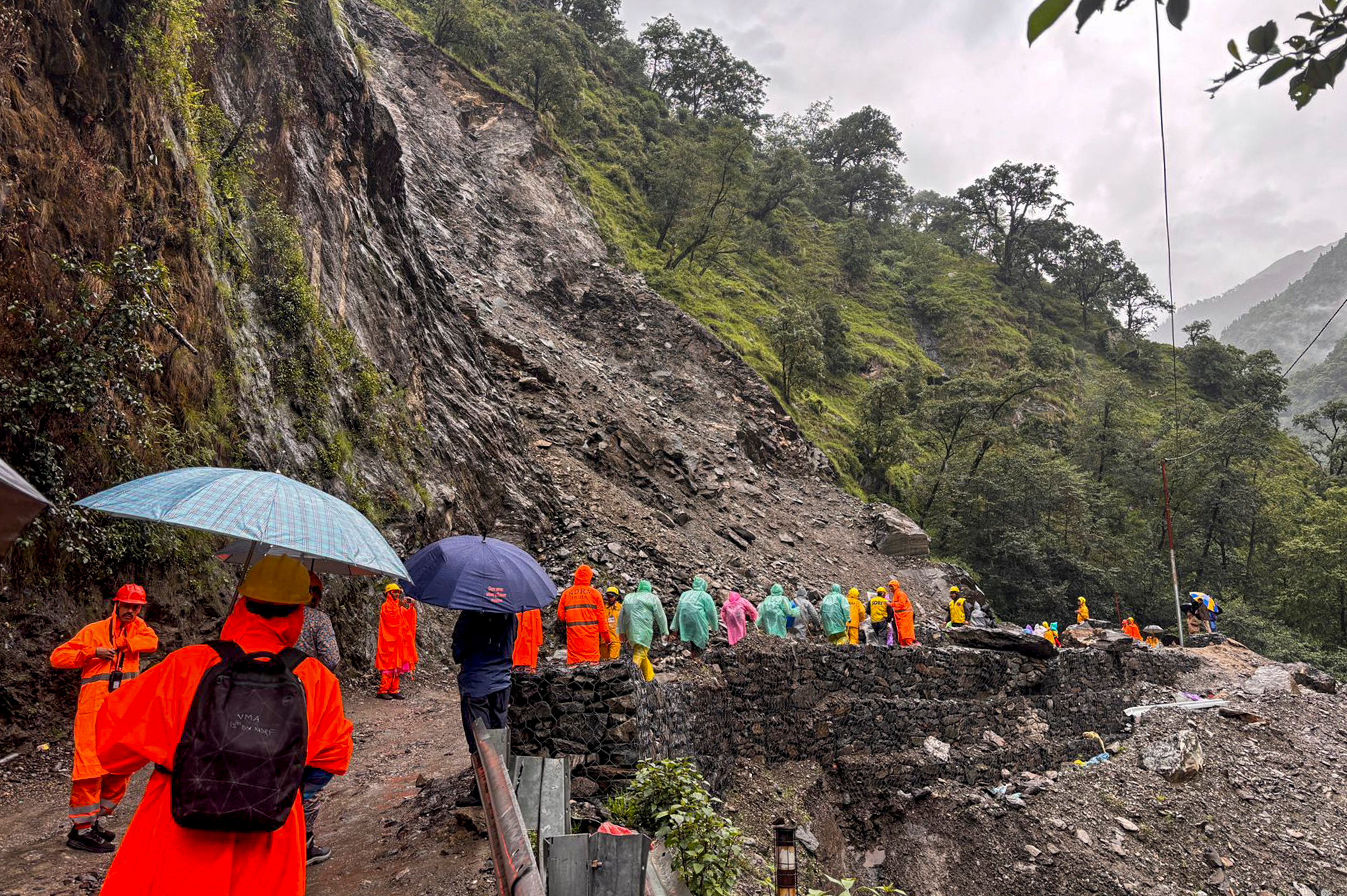 SDRF personnel and officials clearing the debris. (PTI)