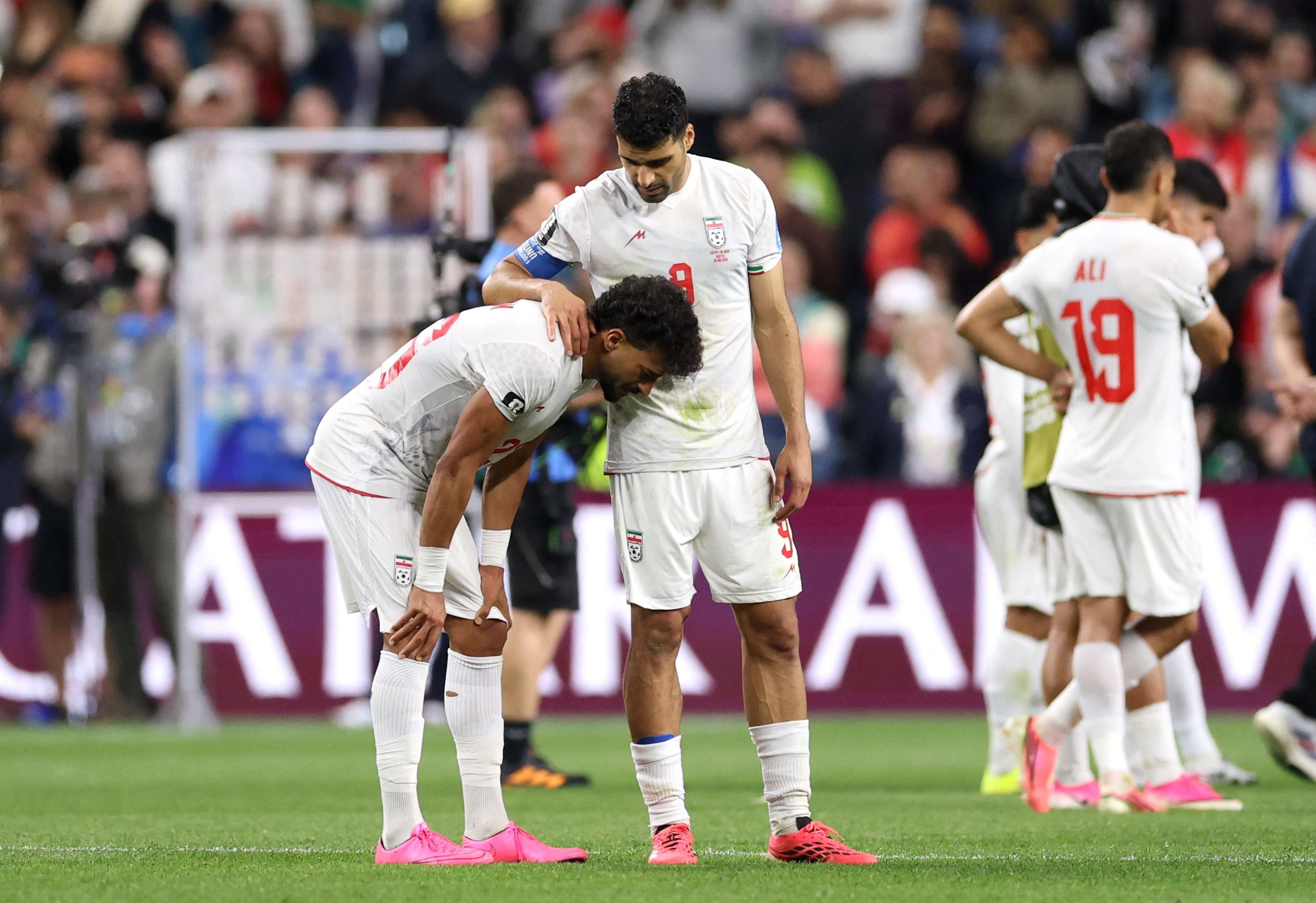 Iran captain Mehdi Taremi (right) consoles Ramin Rezaeian after the 1-1 draw against Egypt in Seattle. (AFP)