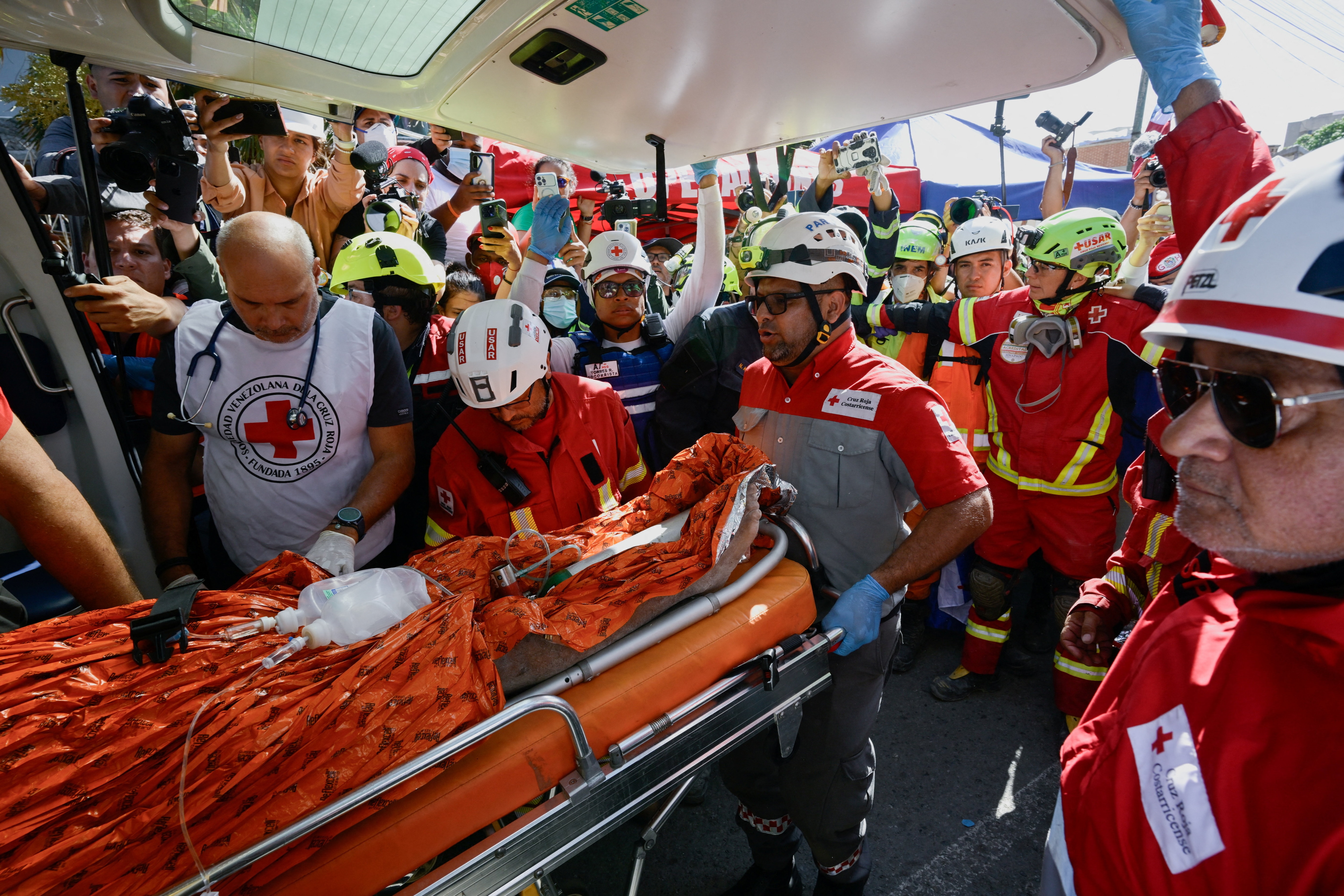 Rescue workers transport survivor Hernan Alberto Gil, who was trapped for over a week at a collapsed mall following June 24 earthquakes, in La Guaira, Venezuela, July 2, 2026. (REUTERS)