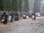 Commuters wade through a severely waterlogged road amid rainfall, in Mumbai, Maharashtra, Friday, July 3, 2026.