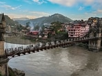 The swollen Beas river flows past the Victoria Bridge on a cloudy evening, in Mandi, on Thursday. (PTI)
