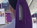 The man can be seen seated on an aircraft with his family WhatsApp group open.