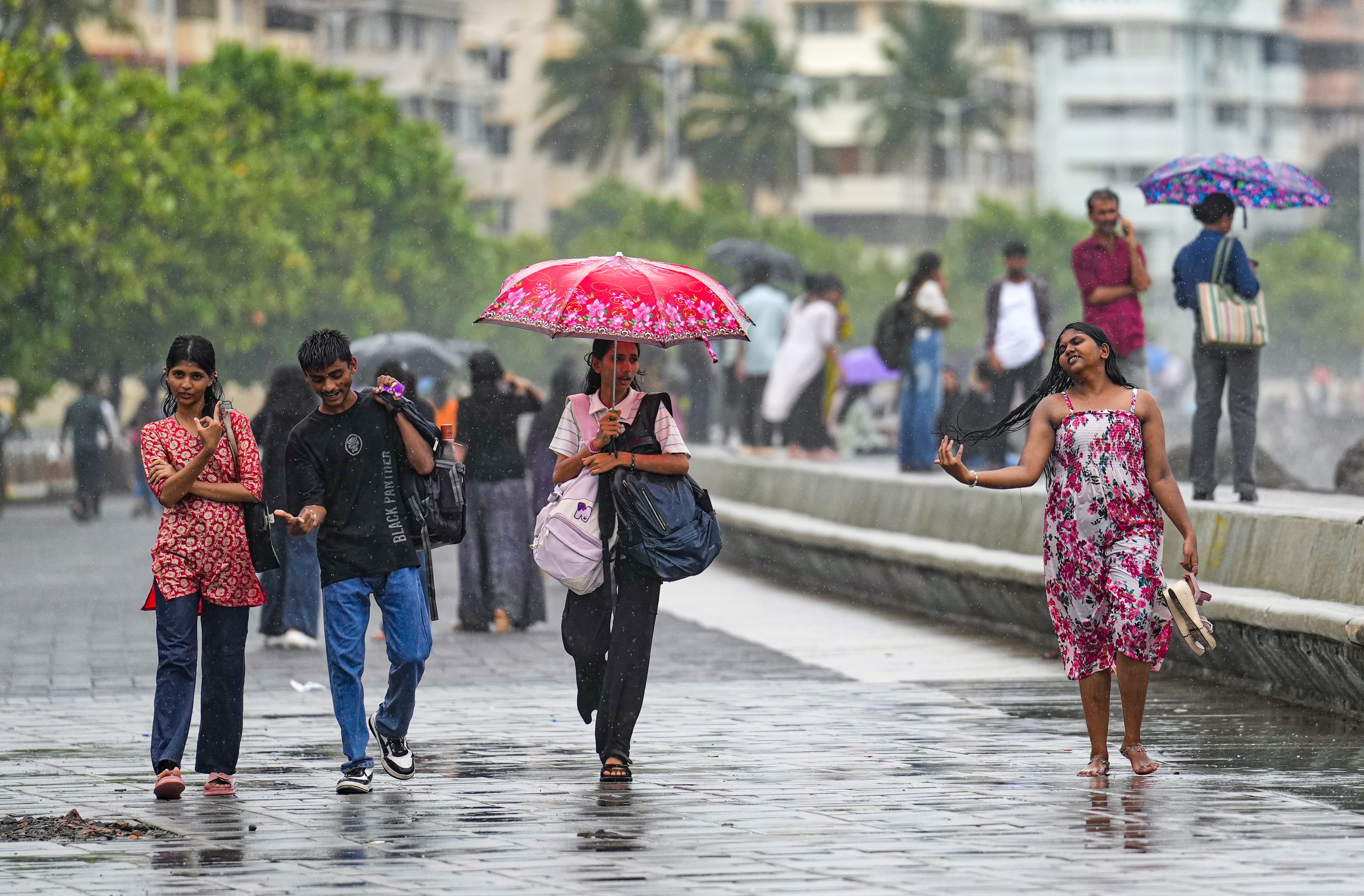 Mumbai: People walk along the promenade on a rainy day at Marine Drive, in Mumbai, Maharashtra, Friday, July 3, 2026. (PTI) Mumbai: People walk along the promenade on a rainy day at Marine Drive, in Mumbai, Maharashtra, Friday, July 3, 2026. (PTI)