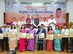 Uttarakhand Chief Minister Pushkar Singh Dhami poses for a group photo as he hands over appointment letters to the newly selected officers at the Chief Servant's Residence, in Dehradun on Friday. 