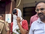 Avinash Shukla, an accused in the Ram temple donation case, in police custody in Ayodhya on Friday. (PTI PHOTO)