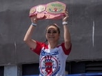 Competitive eater Miki Sudo raises a champion belt as she arrives at the 2025 Nathan's Famous Fourth of July hot dog eating contest in the Coney Island section of the Brooklyn borough of New York, Thursday, July 4, 2025. (AP Photo/Yuki Iwamura,File)