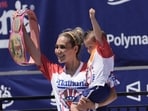 Competitive eater Miki Sudo gives holds cheers with the fans after winning the women's 2026 Nathan's Famous Fourth of July hot dog eating contest at Coney Island in the Brooklyn borough of New York, Saturday, July 4, 2026. (AP Photo/Anna Connors)