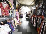 Pedestrian walkways occupied by clothes vendors in Hazratganj (below), leaving little space oom to walk, and (above) the actual space available for walking. (Deepak Gupta/HT Photo)