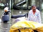 Vegetable-vendor-walks-through-flooded-water-in-BPT-colony-at-Wadala-during-heavy-rain-in-Mumbai