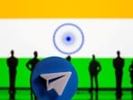 File: A 3D-printed Telegram app logo and small toy figurines are seen in front of India flag in this illustration 
