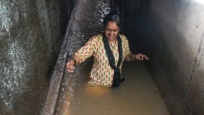 A resident wades through a flooded passage at Ramdas Jivabhai Chawl in Mumbai's Kurla after heavy monsoon rains caused severe waterlogging. (HT/Raju Shakuntala Shinde) A resident wades through a flooded passage at Ramdas Jivabhai Chawl in Mumbai's Kurla after heavy monsoon rains caused severe waterlogging. (HT/Raju Shakuntala Shinde)
