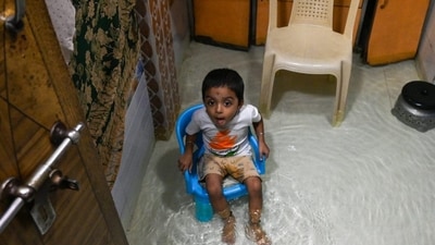 A child sits inside a waterlogged home at Ramdas Jivabhai Chawl in Kurla after heavy rains inundated the area. (HT/Raju Shakuntala Shinde) A child sits inside a waterlogged home at Ramdas Jivabhai Chawl in Kurla after heavy rains inundated the area. (HT/Raju Shakuntala Shinde)