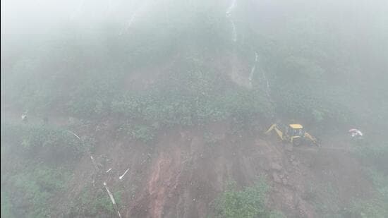 Nearly 100 tourists were stranded on Rajmachi route near Lonavla on Saturday after landslide triggered by incessant monsoon rain blocked the only motorable road with debris. (HT)