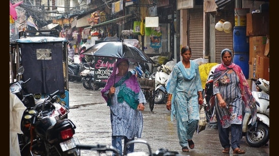 Pedestrians make their way through the rain in Amritsar. The IMD has predicted heavy rain, thunderstorms and gusty winds up to 50 km per hour at isolated places till July 8. (Sameer Sehgal/HT)