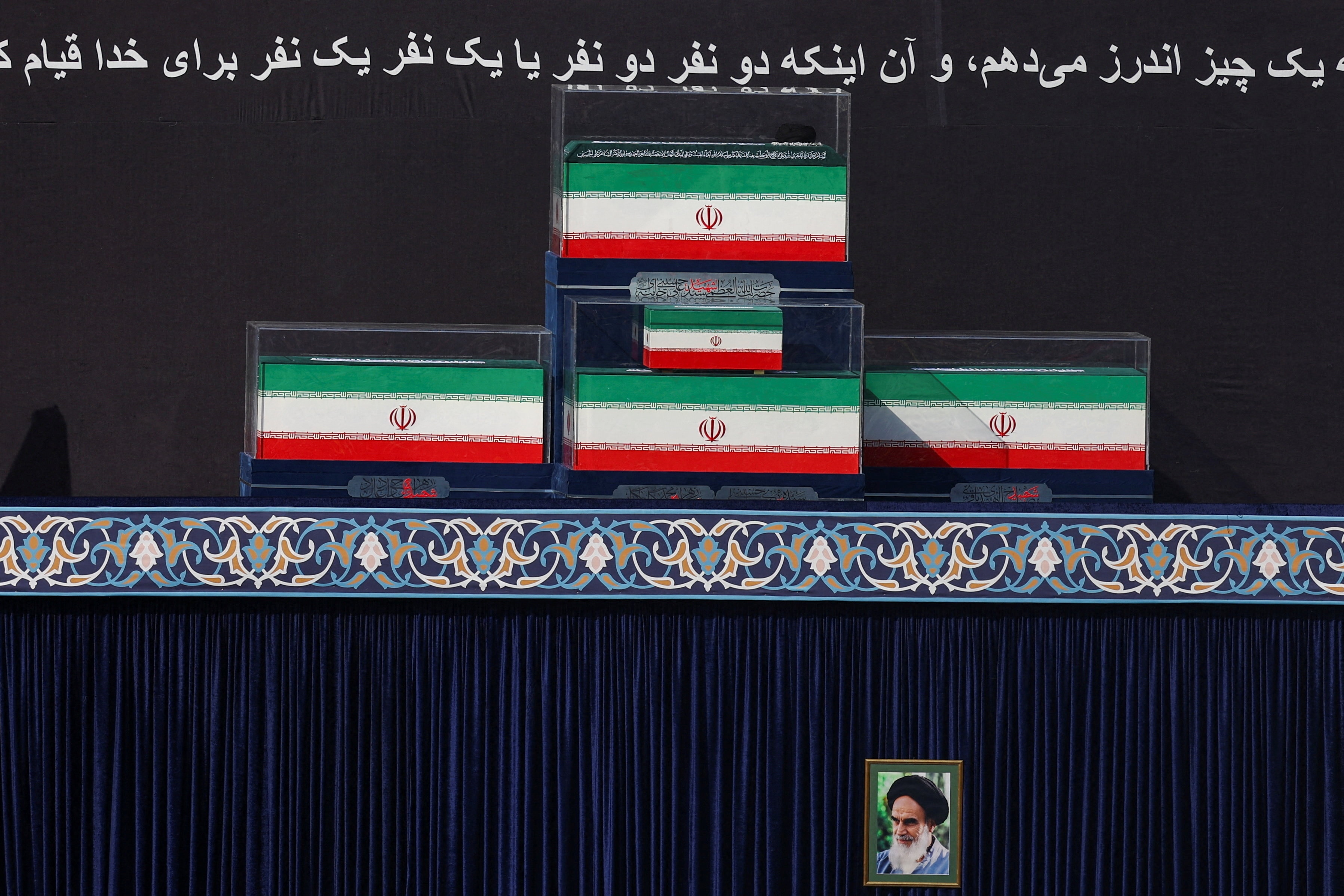 The coffins of Iran's late Supreme Leader Ayatollah Ali Khamenei and his family members in the colours of Iranian flags at the Imam Khomeini Grand Mosalla, in Tehran (REUTERS)