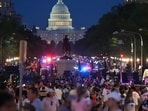 People crowd Pennsylvania Avenue after they were evacuated from the National Mall ahead of severe weather at an Independence Day event and fireworks honoring the nation's 250th anniversary, Saturday, July 4, 2026, in Washington. (AP Photo/Julia Demaree Nikhinson)
