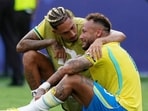 Raphina consoles a crying Neymar Jr after Brazil's Round of 16 exit from the FIFA World Cup against Norway on July 5, 