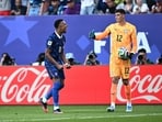 France's Kylian Mbappe celebrates after the match as France qualify for the quarter finals of the World Cup as Paraguay's Orlando Gill looks dejected as Paraguay are eliminated