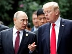President Donald Trump and Russia's President Vladimir Putin talk during the family photo session at the APEC Summit in Danang